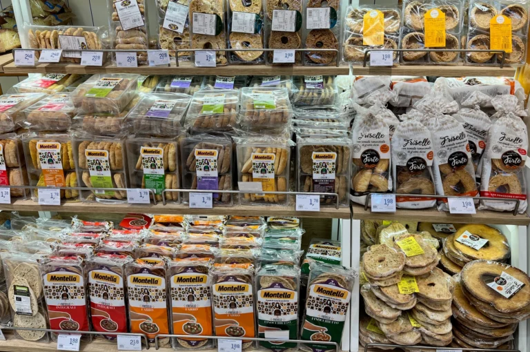 Shelves filled with packets of Italian breads and biscuits.
