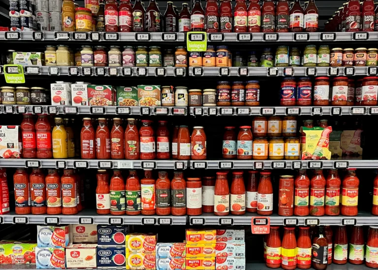 Shelves of bottled sauces, passata and tinned tomato products.